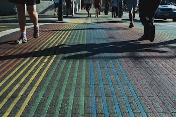 people walking on multicolored pinstriped ground