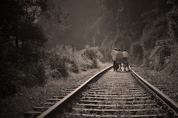 People Walking on Railroad Tracks