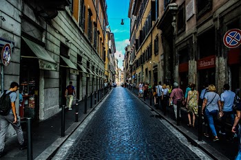 People Walking on Sidewalk Beside Road