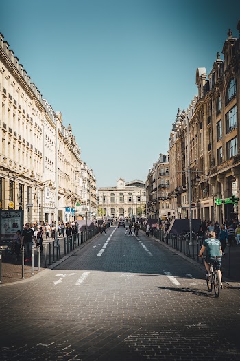 People Walking On Sidewalks Beside Buildings