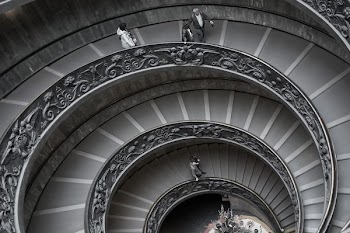people walking on spiral staircase