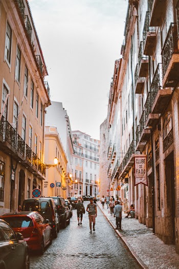 People Walking Through Alley