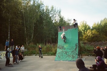 People Watching Person Skating on Green Ramp