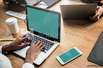 People working on a laptop in a meeting
