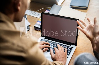 People working on a laptop in a meeting