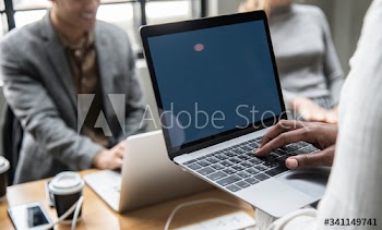 People working on a laptop in a meeting