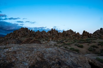 Perfect sunset in Alabama Hills, CA with full moon over rock peak.  This was taken during mid May. 