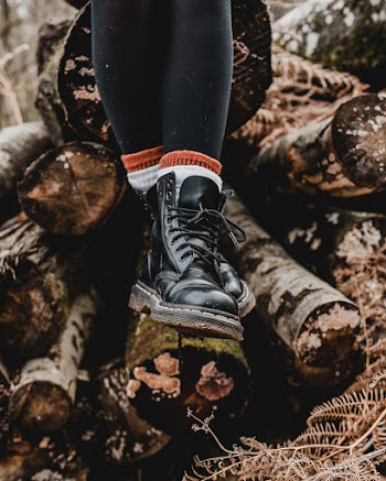Persn Wearing a Pair of Black Boots
