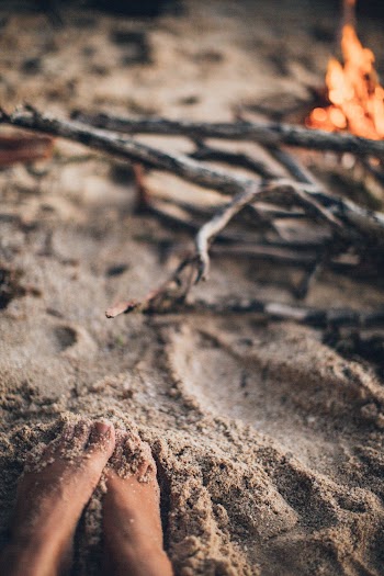 Person's Feet Beside Bonfire