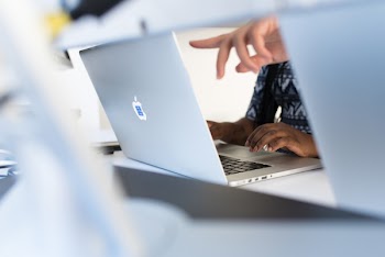 Person's Fingers Pointing in Macbook Pro