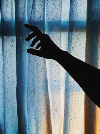Person's Hand Near Curtain