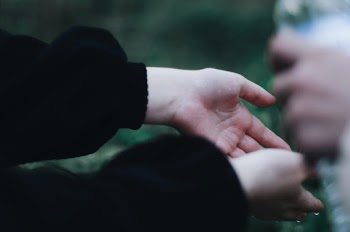 Person's Hands With Water Droplets