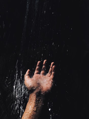 Person's Left Hand Catching Water