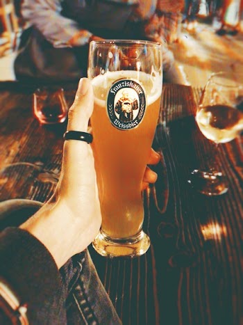 Person's Left Hand Holding Clear High Glass
