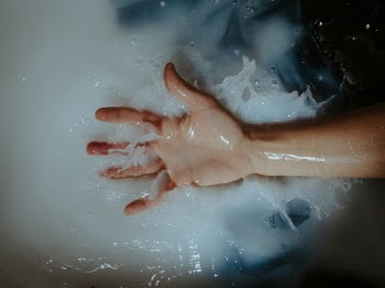 Person's Right Palm over White Liquid