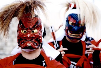 Person's Wearing Red and Blue Kabuki Masks