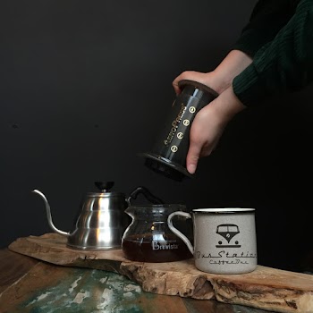 Person About to Put Aeropress Top Into Carafe