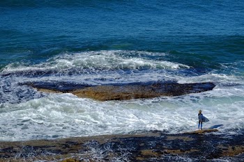 person about to surf on shore