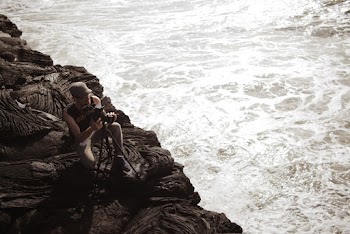 Person Assembling Camera Stand Near Shore