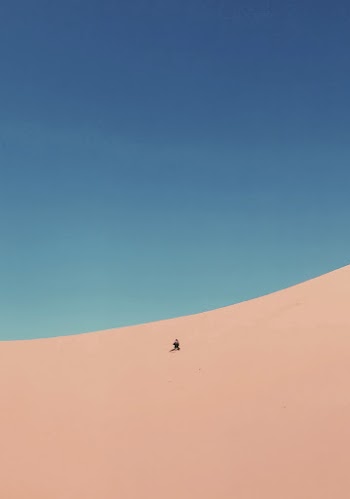 Person At A Desert Under Blue Sky