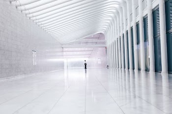 person at end of lobby facing columns