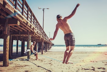 Person Balancing On Blue Rope