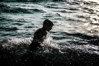 Person Bathing in Body of Water