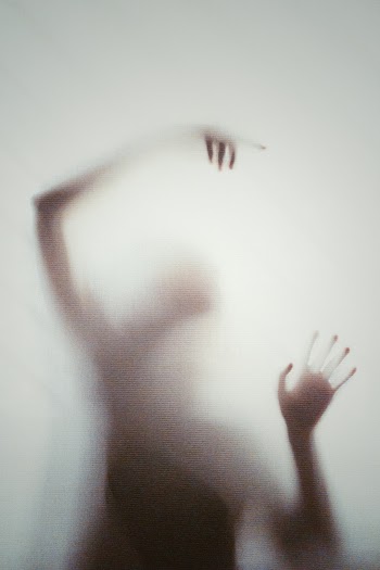 Person Behind a Frosted Glass Wall