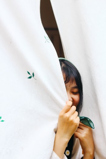 Person Behind Curtains