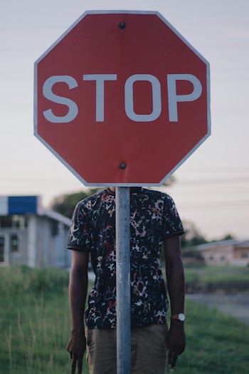 Person Behind Stop Signage