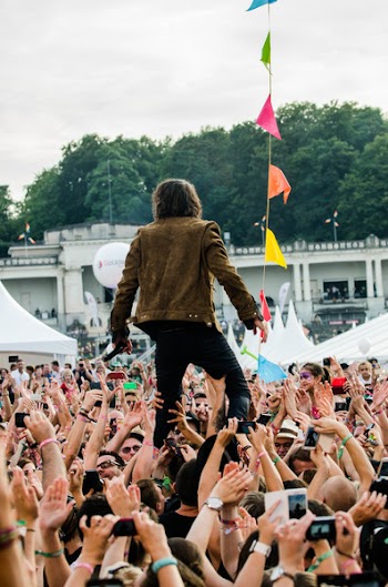 Person Being Carried by Crowd