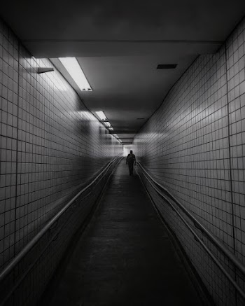 Person Between Tiled Walls