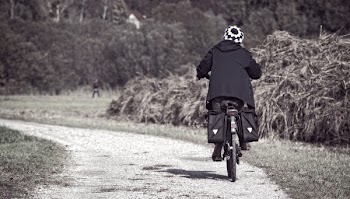 Person Biking in Dirt Road
