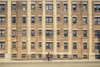 Person Biking Near Building
