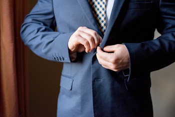 Person Buttoning His Coat