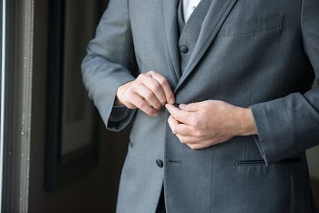 Person Buttoning Suit Jacket