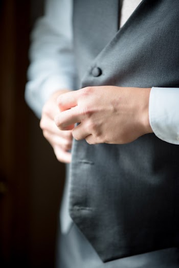 Person Buttoning Vest
