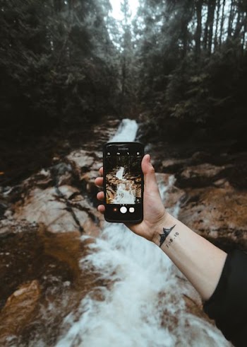 person capturing river