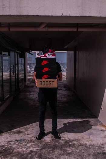 Person Carries Boxes of Shoes