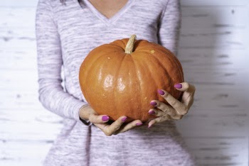Person Carrying a Pumpkin