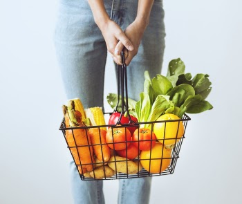 Person Carrying Basket of Vegetables