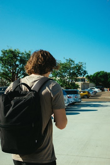 Person Carrying Black Backpack