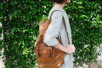 Person Carrying Brown Leather Knapsack