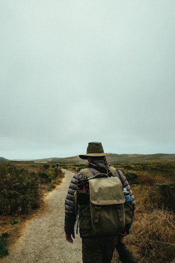 Person Carrying Gray Knapsack Backpack