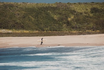 Person Carrying White Surfboard