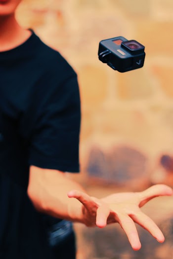 Person Catching Black Action Camera