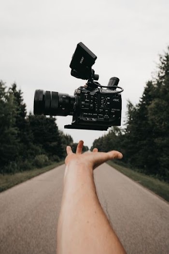 person catching black Sony camcorder