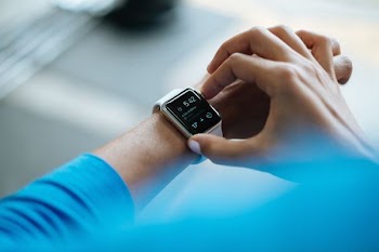 person clicking smartwatch