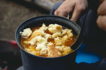 Person Cooking Food in Casserole
