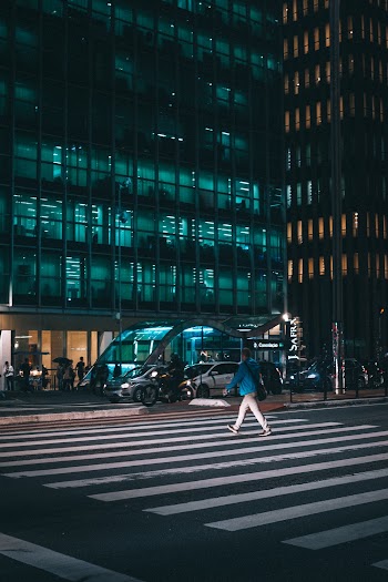 Person Crossing on Road during Night Time
